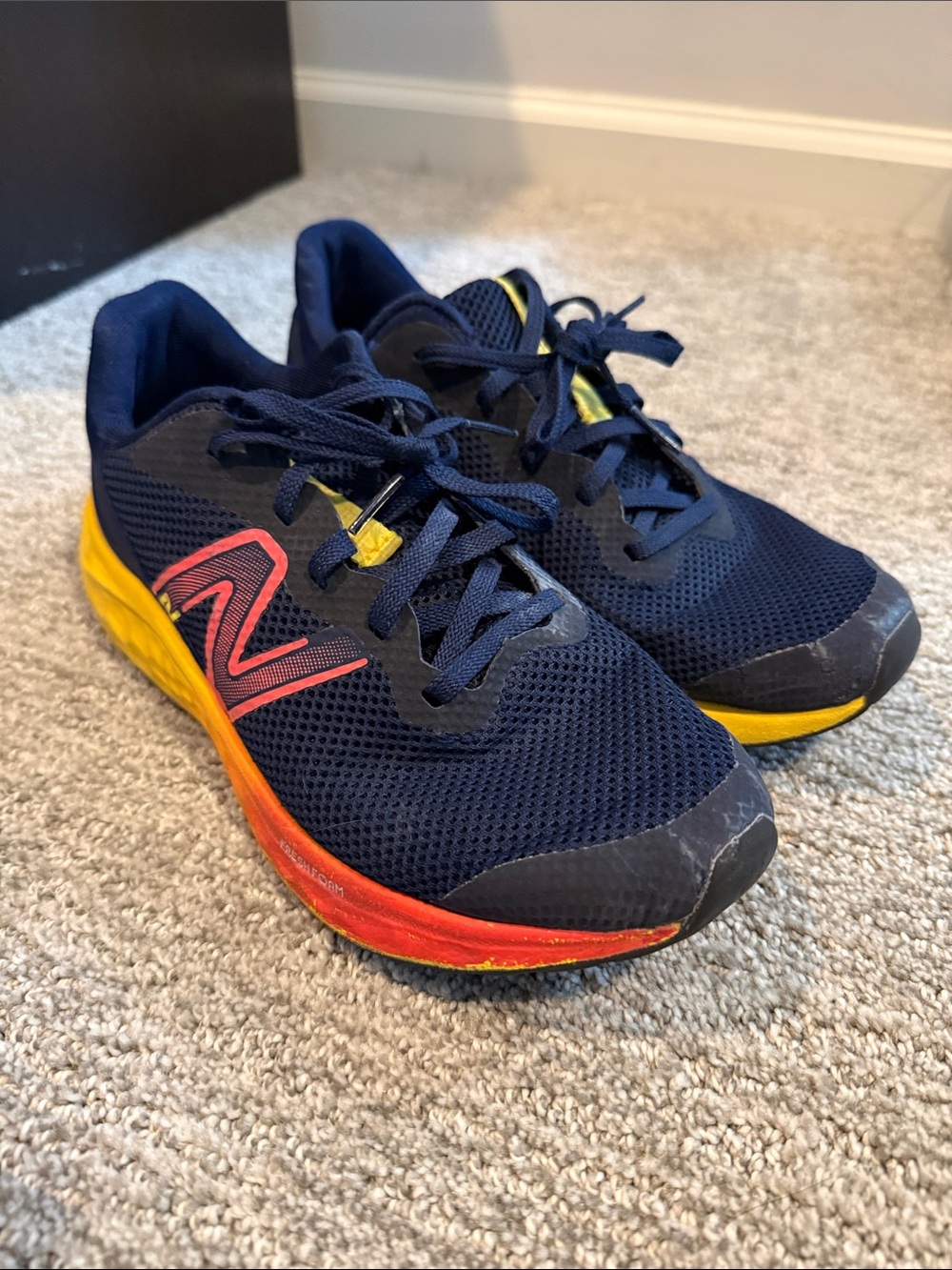 New Balance Kids Navy Sneakers with Yellow and Red Accents